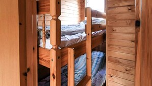 A bunk bed room with wooden walls and a window. - 6 Person Holiday Park Home in Asperup (Middelfart)