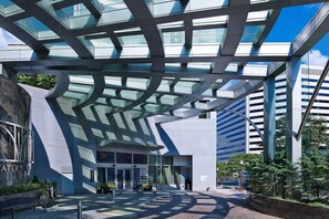 A modern building with a glass facade and a unique geometric roof structure. - Chic D.C. Stay | Potomac Views. Steps to Metro (Arlington)