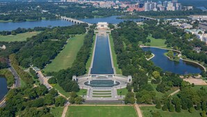 An aerial view of a park with a central monument, pathways, and surrounding greenery. - Georgetown Views | Fitness Center. Great Events (Arlington)
