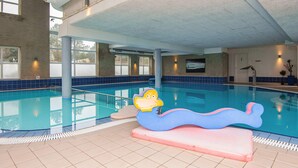 An indoor swimming pool with a lifeguard stand, tiled walls, and a large window. - 4 Person Holiday Park Home in Romo (Rømø)