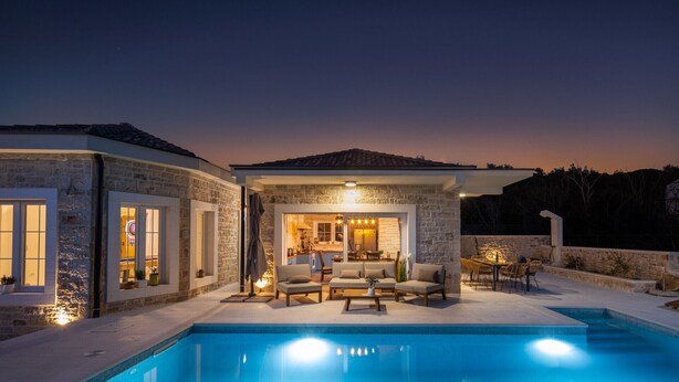 A modern house with a swimming pool, stone walls, and outdoor seating area. - Villa Katarina with pool (Zadar)