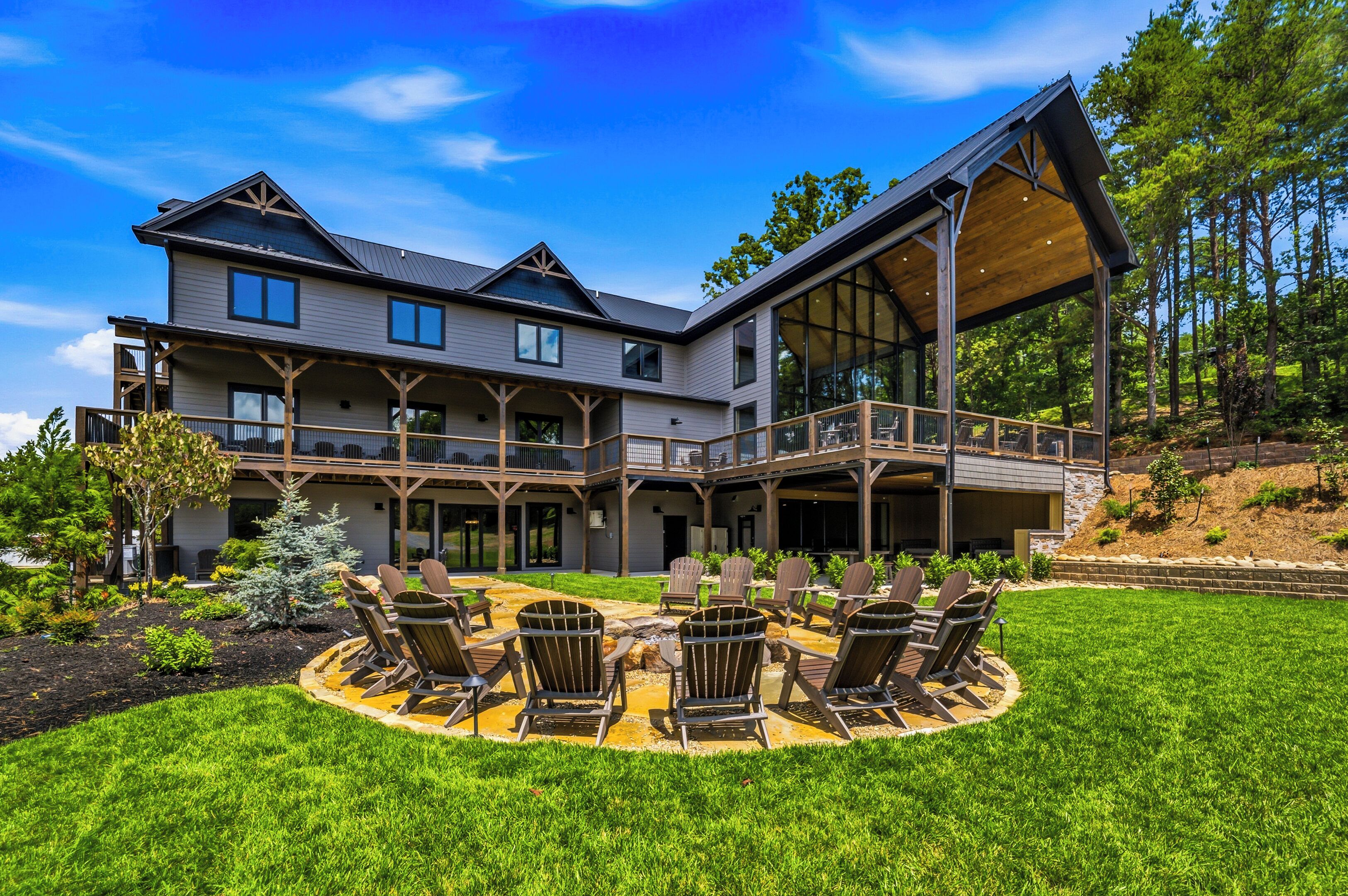 A large two-story house with a covered patio area and outdoor seating.