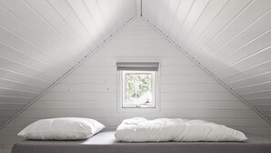 A small, single-bed room with a sloped ceiling and a window. - 6 Person Holiday Park Home in Malling (Malling)