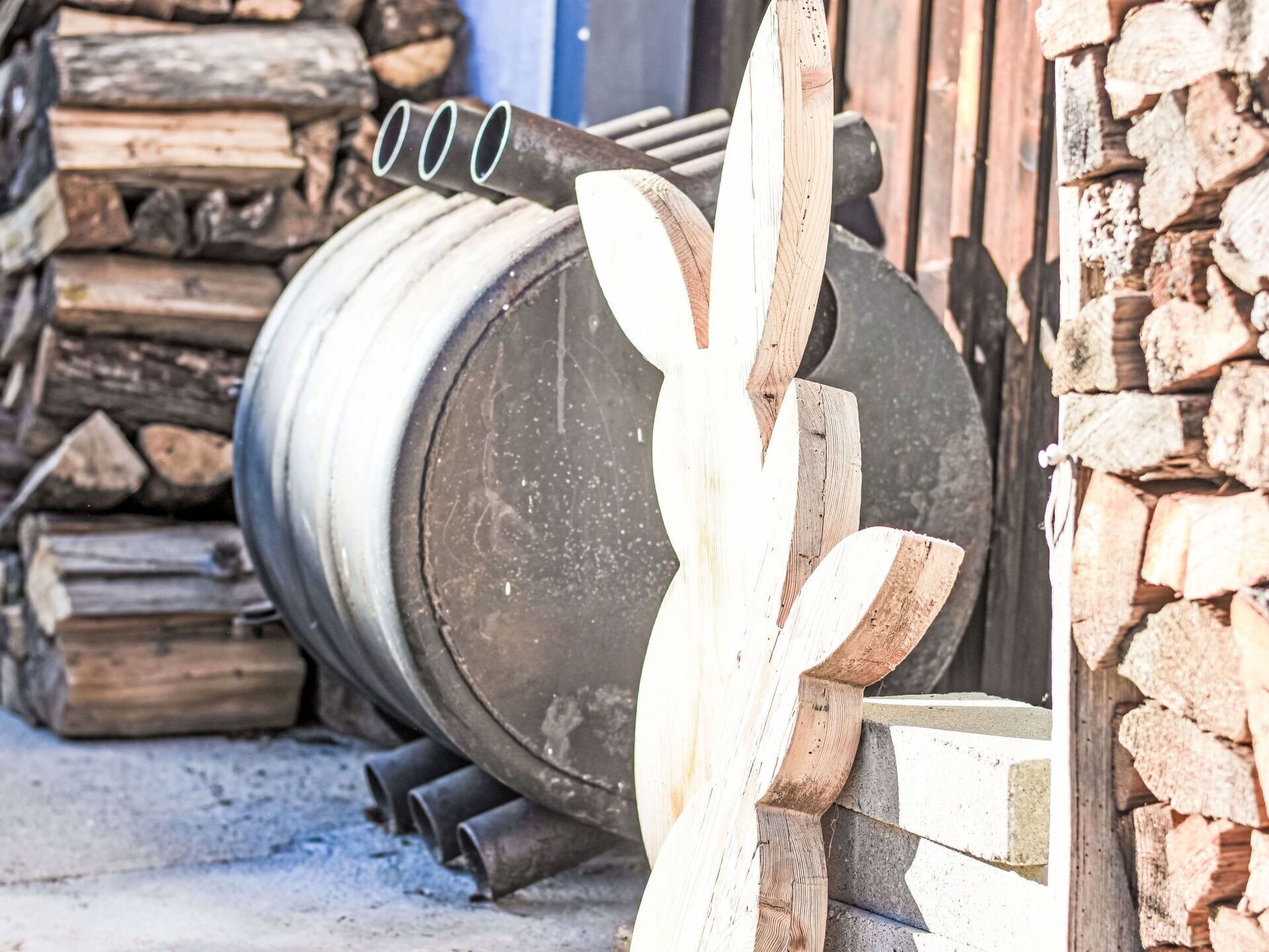 A large cylindrical object, possibly a barrel or tank, with a metal pipe attached to its side.