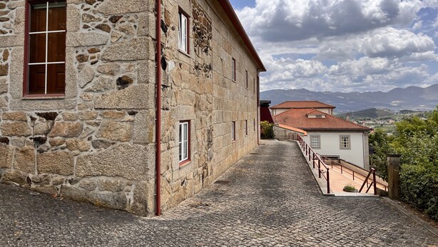 A stone building with a cobblestone path leading to a white building with a red roof. - Nomad s Country - Cimo de Vila The Poolside Haven (Cabeceiras de Basto)