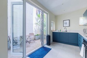Een moderne keuken met een blauw aanrecht, een spoelbak en een fornuis.