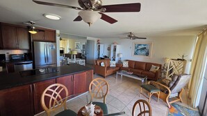 A spacious living area with a kitchen, dining area, and a balcony.