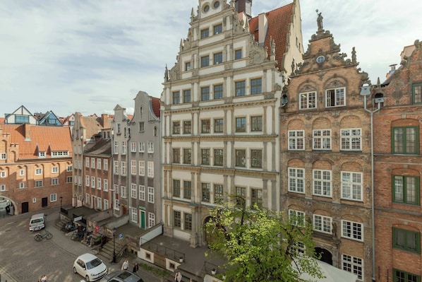 A historic building with multiple stories, large windows, and a prominent central tower.