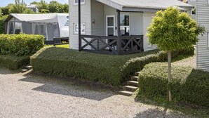 A small, single-story mobile home with a porch and a covered outdoor area. - 8 Person Holiday Park Home in Faaborg (Faaborg)