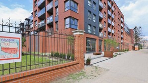 A multi-story residential building with a brick facade and balconies.