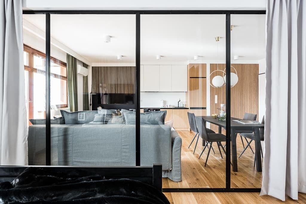 Eine moderne Wohnung mit Wohnbereich, Küchenzeile und Essbereich.
