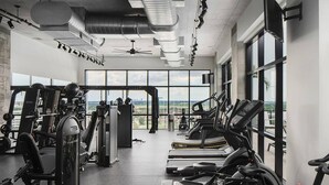 A gym with various exercise equipment, large windows, and a view of the cityscape. - Landing | Chic 2BD, Gym (St. Petersburg)