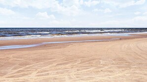 A beach with a sandy shore and ocean waves. - 6 Person Holiday Park Home in Pandrup (Pandrup)