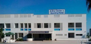 A modern hotel named Star Center Sporting Hotel with a clear sky and a sign indicating a 10 km distance. - [Panoramic and 90 meters from the sea] (Castel Volturno)