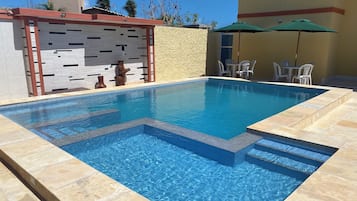 Outdoor pool, open 8:00 AM to 9:00 PM, pool umbrellas