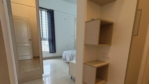 A hotel room with a bed, a wardrobe, and a bathroom.