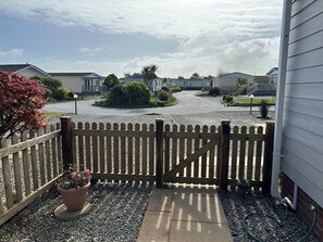 A gated driveway leading to a residential area with houses and a clear sky. - Stargazey - Lovely, 4 Bedrooms en-suite to master, secure garden,  Free WIFI (st merryn park)
