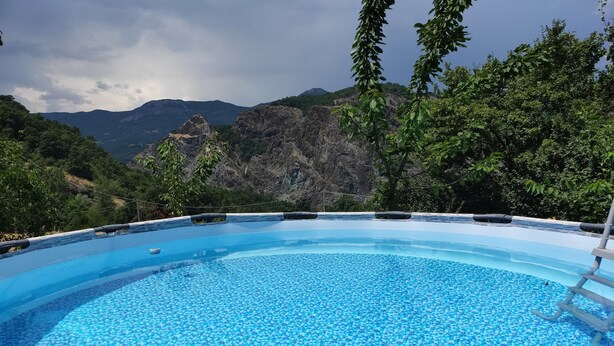 A swimming pool with a clear view of mountains in the background.