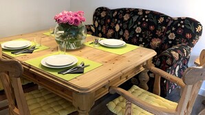 A dining table set with plates, cutlery, and a vase of flowers. - Winterberg Apartment 21041 (Winterberg)