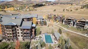 A resort with multiple buildings, a swimming pool, and a hot tub. - Pool & Hot Tubs | Nextdoor to Pickleball | Air Conditioning (Steamboat Springs)