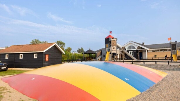 A playground with a colorful slide and a small tower. - 5 Person Holiday Park Home in Holbaek (Holbaek)
