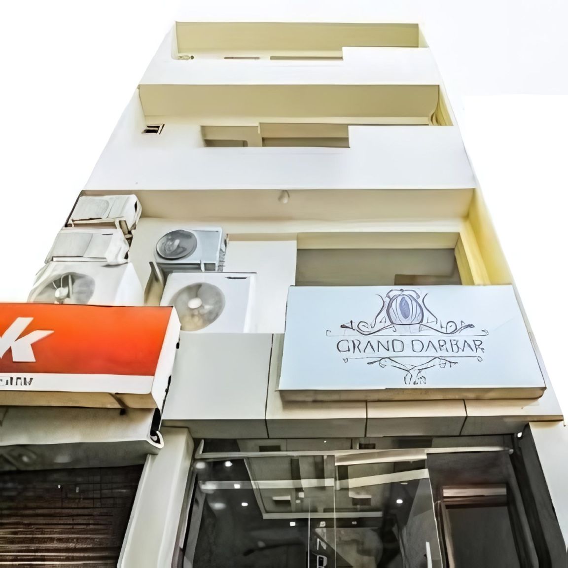 A building with a sign for 'GRAND DARBAR' and an 'A' logo.
