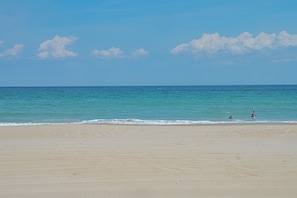 A beach with a clear sky and calm sea. - HOT TUB! Four bedroom home in the 4X4, Corolla, NC. A truly unique getaway! (Corolla)
