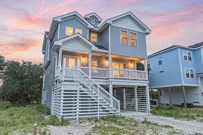 A multi-story house with a balcony, a staircase, and a porch. - HOT TUB! Four bedroom home in the 4X4, Corolla, NC. A truly unique getaway! (Corolla)