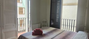 A room with a bed, a window, and a balcony. - Acomodis great location right in El Born old town 4 air conditioners 6 ppl max.! (Barcelona)