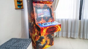 A video game arcade machine with 'Mortal Kombat' branding, a control panel, and a 'Fatality' button.