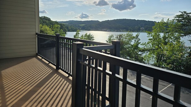 A balcony with a view of a lake and hills. - Executive Edge, Lakeside (Bean Station)