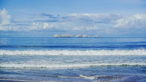 A coastal view with calm waves and distant islands. - Portofino Hotel & Restaurante (Barra de Potosi)