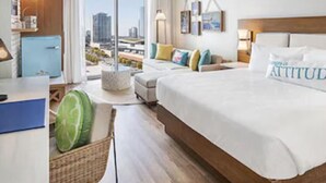 A hotel room with a large bed, a desk, a chair, a small kitchenette, and a view of the city. - Margaritaville Vacation Club - Nashville, Studio Suite close to everything (Nashville)