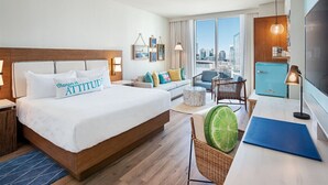 A hotel room with a large bed, a city view, a kitchenette, and a seating area with a table and chairs. - Margaritaville Vacation Club - Nashville, Studio Suite close to everything (Nashville)