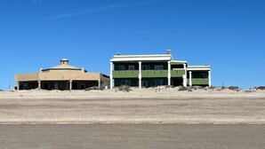 A building with a dome and a rectangular structure with multiple windows.
