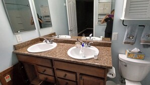 A bathroom with two sinks, a mirror, and a toilet. - Charming 1-bedroom house in Riverside (Riverside)