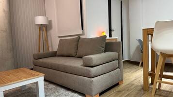 A living room with a sofa, a coffee table, and a chair.