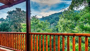 A wooden deck with a railing overlooking a forested hillside. - HUGE Heated Indoor Pool, 2 King Beds, A+ Location, Arcade (Sevierville)