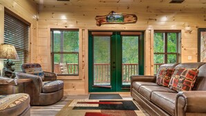 A cozy cabin interior with a leather sofa, armchairs, and a wooden ceiling. - HUGE Heated Indoor Pool, 2 King Beds, A+ Location, Arcade (Sevierville)