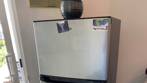 A stainless steel refrigerator with a freezer compartment, a handle, and a freezer compartment door.