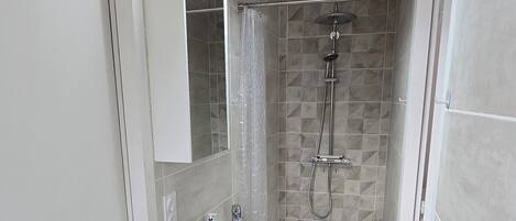 Shower, hair dryer, towels, toilet paper