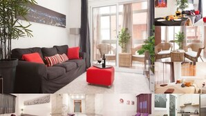 Habitación de hotel moderna con sofá, reposapiés rojo y vistas a la ciudad.