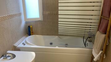 Bidet, towels, soap, toilet paper