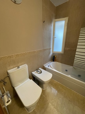 Een bidet, handdoeken, zeep, toiletpapier