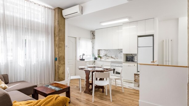 A modern apartment with a living area, dining space, and kitchen.