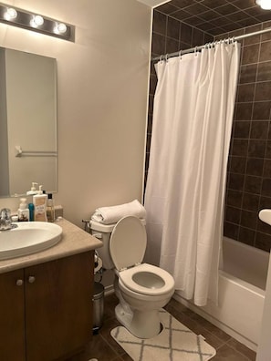 A bathroom with a toilet, sink, and shower curtain. - Private Ensuite Bedroom in Ajax (Ajax)