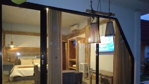 A room with a bed, a desk, and a chair. There is a window with curtains, and a hanging lamp. - Rustic 2 bedrooms villa near Obsidian Gym (Bali)