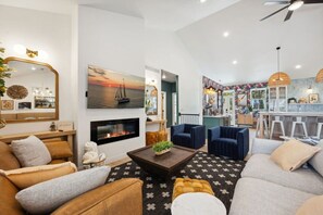 A living room with a fireplace, sofas, and a coffee table.