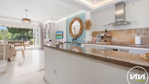 A modern kitchen with a granite countertop, a stainless steel range hood, and a built-in dishwasher. - Lochloosa | Pool - terrace - golf (Marbella)