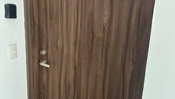 A wooden door with a keyhole and a handle.